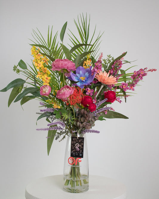 Artificial tropical floral arrangement with colourful pink, yellow, purple, orange, and blue