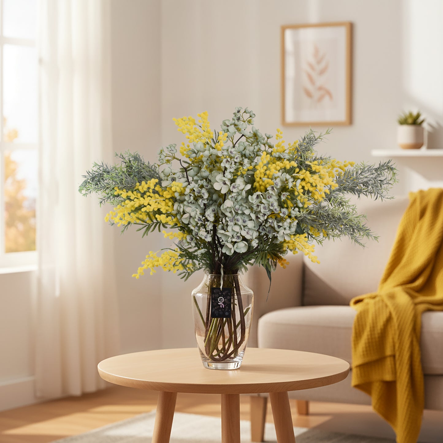 Bouquet of yellow and white flowers in a clear vase on a wooden table in a living room.