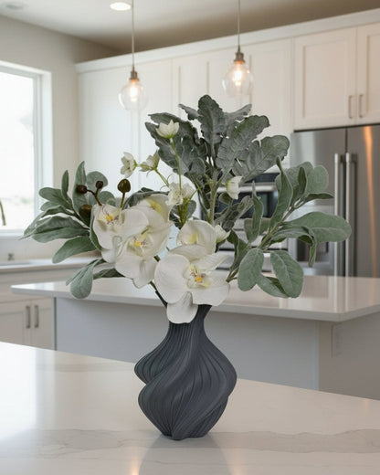 Gray vase with white flowers on a kitchen counter