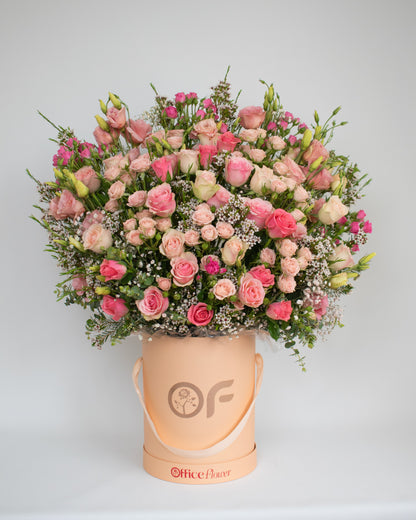 Romantic pink rose bloom box featuring layers of premium roses and seasonal flowers