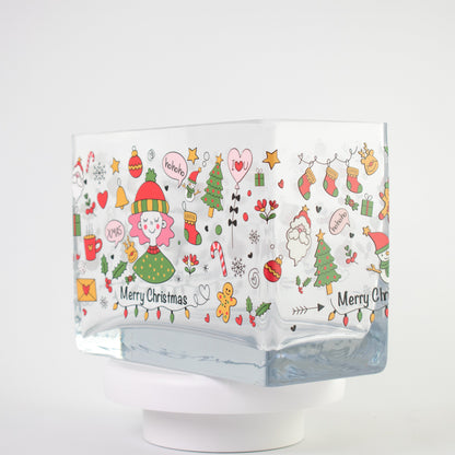 Clear glass vase with a colourful Christmas design featuring Santa, candy canes, gifts, stars, and “Merry Christmas” text — size 20x10x15 cmH.