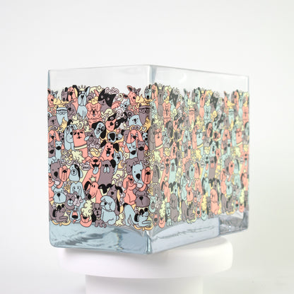 Clear glass vase with a colourful cartoon dog pattern in coral, teal, grey, and beige tones — size 20x10x15 cmH.