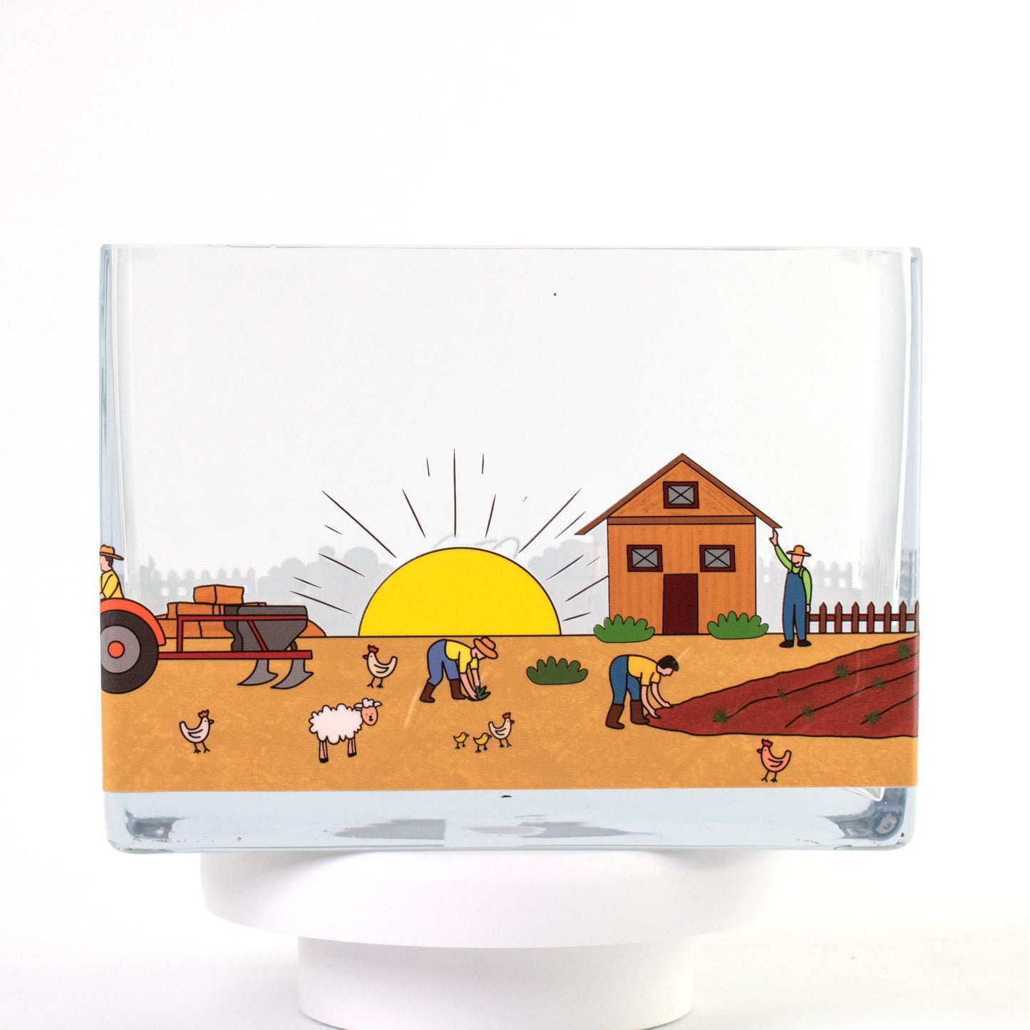 Clear glass vase with a colourful farm design featuring sunrise, barn, farmers, tractor, and animals — size 20x10x15 cmH.