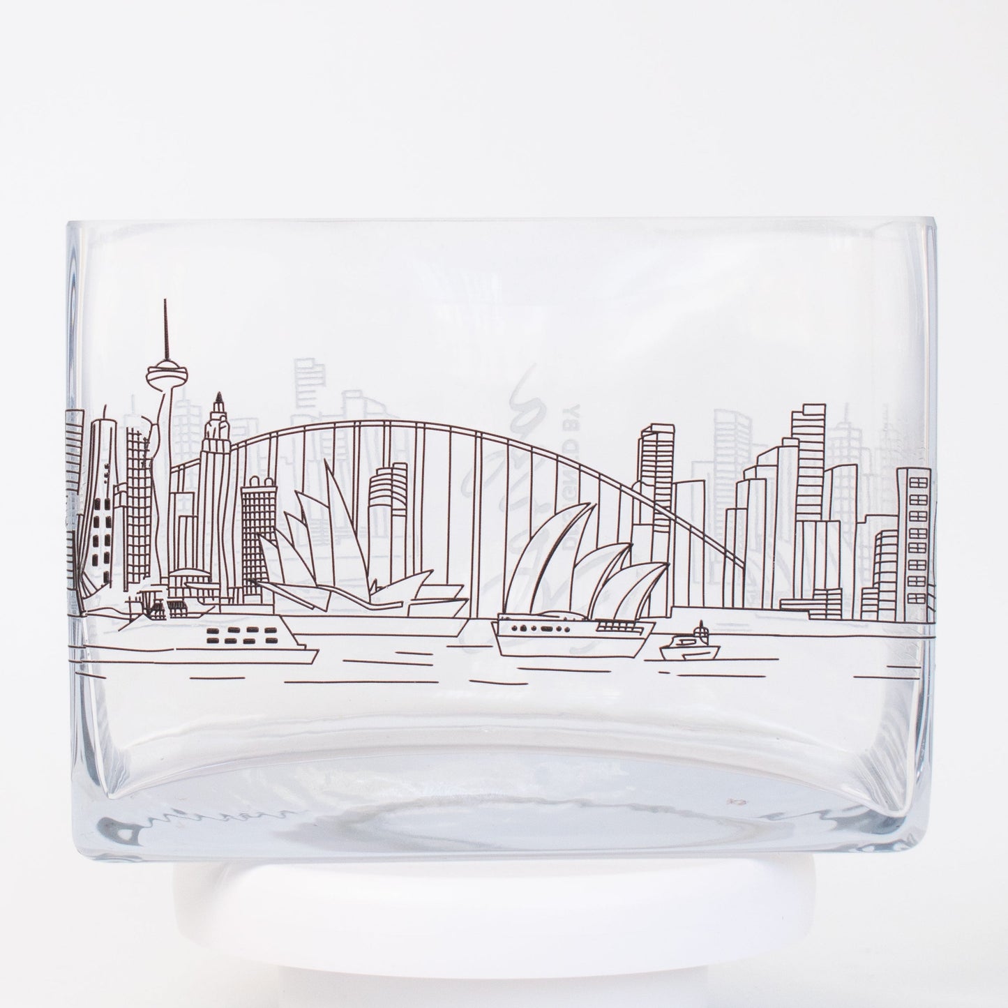 A clear rectangular glass vase featuring a fine-line illustration of the Sydney skyline, including the Opera House, Harbour Bridge, and city buildings.
