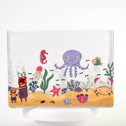 Clear glass vase with a colourful underwater scene featuring octopus, crab, jellyfish, fish, and coral — size 20x10x15 cmH.